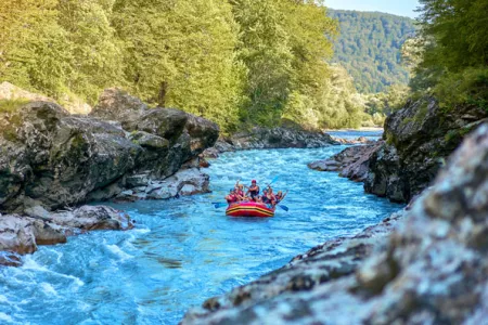 Ein Team von Abenteurern geht auf Wildwasser-Rafting-Abenteuer in einem Bergfluss während ihres Kururlaubs.